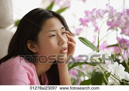 Young woman looking pensively into distance View Large Photo Image Stock Photo - Young woman looking pensively into distance. Fotosearch