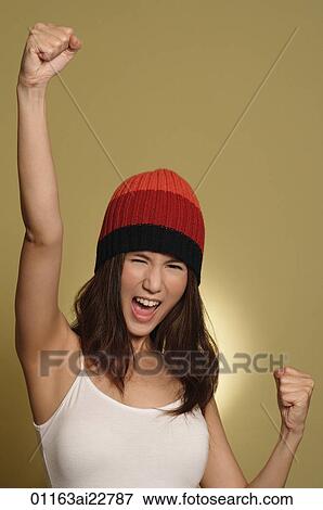 Stock Photo - Young woman making fist in air. Fotosearch