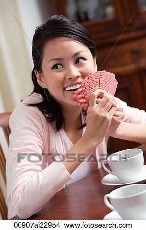 Picture - Young woman playing cards. Fotosearch