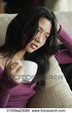 Young woman relaxing with cup of tea View Large Photo Image Stock Photography - Young woman relaxing with cup of tea. Fotosearch