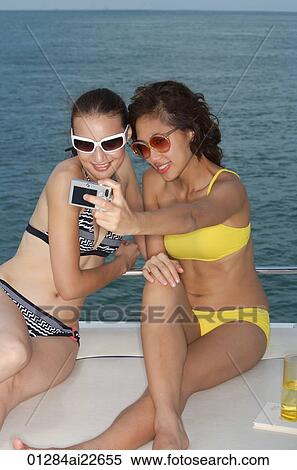 Young women taking pictures of themselves View Large Photo Image Stock Photography - Young women taking pictures of themselves. Fotosearch