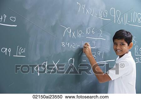 Stock Image - boy at chalkboard, smiling at camera. Fotosearch