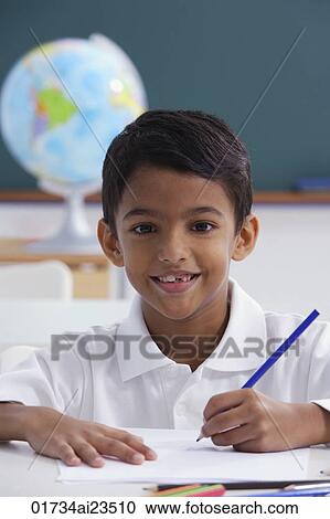boy at desk with blue pencil View Large Photo Image Stock Image - boy at desk with blue pencil. Fotosearch
