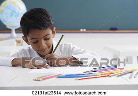 boy concentrates on schoolwork View Large Photo Image Picture - boy concentrates on schoolwork. Fotosearch