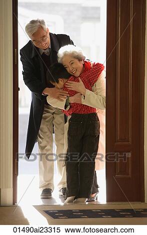 Boy greeting grandparents at door View Large Photo Image Stock Photography - Boy greeting grandparents at door. Fotosearch