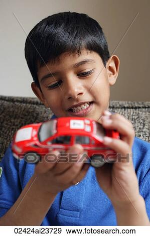 boy holding red car (vertical) View Large Photo Image Stock Photo - boy holding red car (vertical). Fotosearch