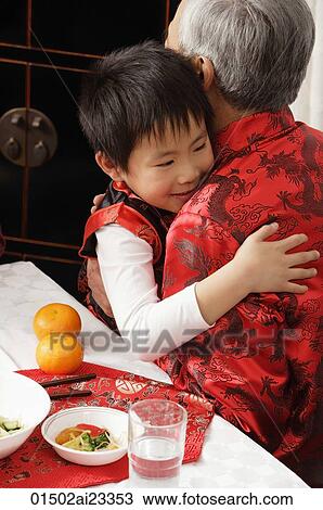Stock Image - Boy hugging grandfather. Fotosearch