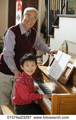 Boy playing piano for grandfather View Large Photo Image Stock Photo - Boy playing piano for grandfather. Fotosearch