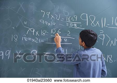 Stock Image - boy working at chalkboard (back view). Fotosearch