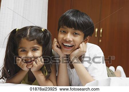 Brother and sister on bed View Large Photo Image Stock Photography - Brother and sister on bed. Fotosearch