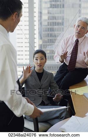 Stock Photograph - business associates talking. Fotosearch
