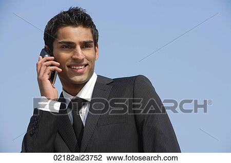 Stock Image - business man on phone, smiling. Fotosearch