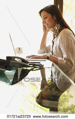 business woman working at laptop (profile) View Large Photo Image Stock Photography - business woman working at laptop (profile). Fotosearch