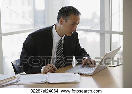 businessman at table with laptop View Large Photo Image Picture - businessman at table with laptop. Fotosearch