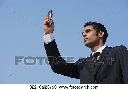 Stock Image - businessman checks his messages (horizontal). Fotosearch