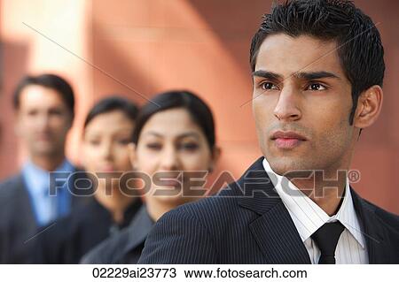 businessman in foreground, three colleagues in background View Large Photo Image Stock Image - businessman in foreground, three colleagues in background. Fotosearch