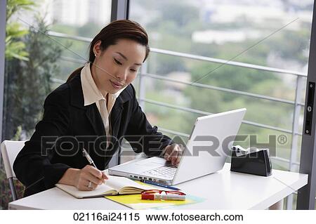 Stock Photography - businesswoman at laptop. Fotosearch