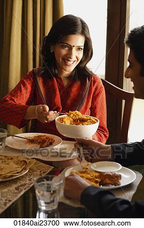 couple at dinner table, woman serving food View Large Photo Image Stock Image - couple at dinner table, woman serving food. Fotosearch