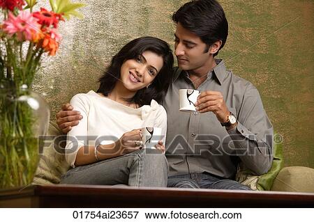 couple hold up tea cups, man looks at woman View Large Photo Image Stock Photo - couple hold up tea cups, man looks at woman. Fotosearch