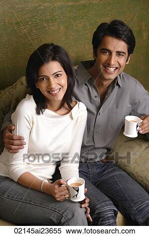couple holding tea cups and smiling at camera View Large Photo Image Stock Photography - couple holding tea cups and smiling at camera. Fotosearch