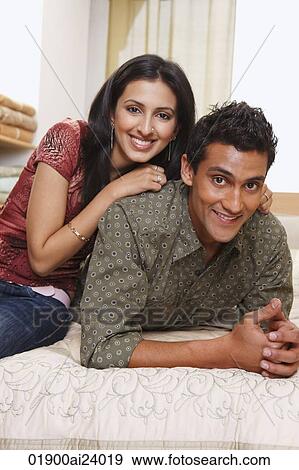 couple lounging on bed View Large Photo Image Stock Photo - couple lounging on bed. Fotosearch