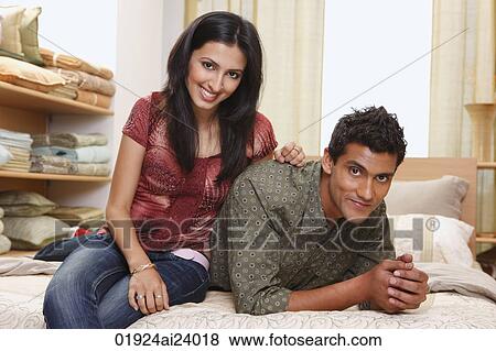 couple lounging on bed View Large Photo Image Stock Photo - couple lounging on bed. Fotosearch