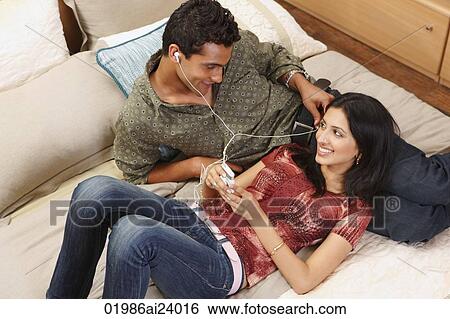 Stock Photograph - couple lounging on bed. Fotosearch