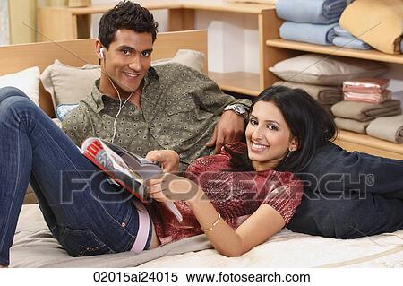 couple lounging on bed View Large Photo Image Stock Photography - couple lounging on bed. Fotosearch