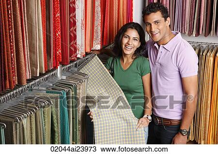 Stock Image - couple shopping for fabric. Fotosearch