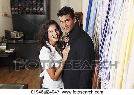 Stock Photo - couple shopping for men's clothing. Fotosearch
