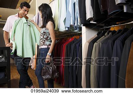 Stock Photo - couple shopping for men's clothing. Fotosearch