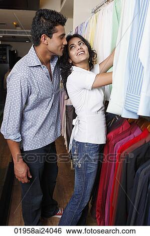 Stock Photograph - couple shopping for men's clothing. Fotosearch