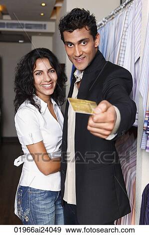 couple shopping, man holding out gold card View Large Photo Image Stock Photo - couple shopping, man holding out gold card. Fotosearch