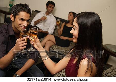 couple toasting each other at party View Large Photo Image Picture - couple toasting each other at party. Fotosearch