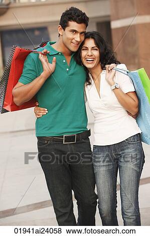 Stock Photo - couple with shopping bags. Fotosearch