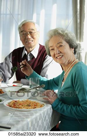 Elderly couple at dinner table View Large Photo Image Stock Image - Elderly couple at dinner table. Fotosearch