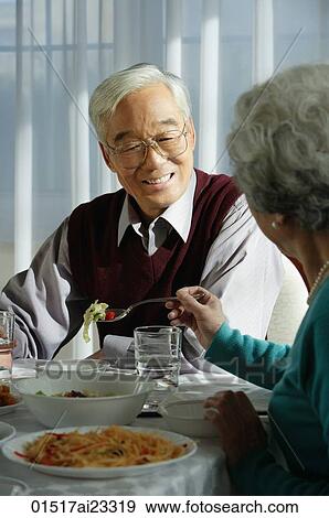 Stock Photo - Elderly couple at dinner table. Fotosearch