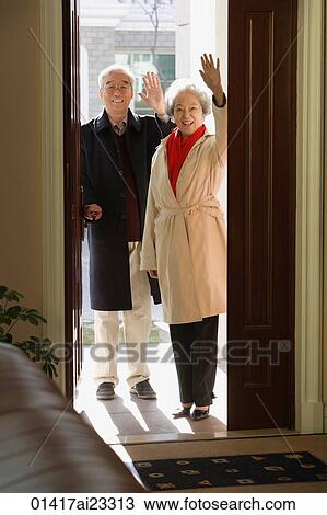Elderly couple in door frame waving at camera View Large Photo Image Stock Image - Elderly couple in door frame waving at camera. Fotosearch