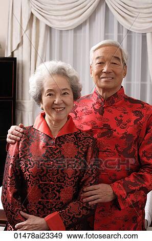 Stock Photo - Elderly couple in traditional clothes smiling at camera. Fotosearch