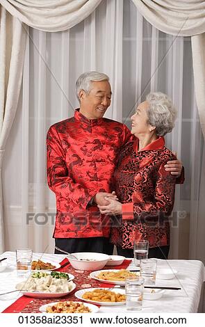Stock Image - Elderly couple in traditional clothing looking at each other. Fotosearch