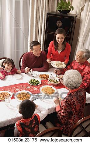Family at dinner table having traditional food View Large Photo Image Stock Photography - Family at dinner table having traditional food. Fotosearch