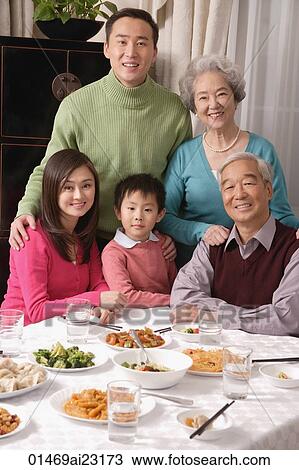 Family at dinner table with traditional food View Large Photo Image Stock Image - Family at dinner table with traditional food. Fotosearch