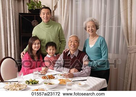 Family at dinner table with traditional food View Large Photo Image Stock Image - Family at dinner table with traditional food. Fotosearch