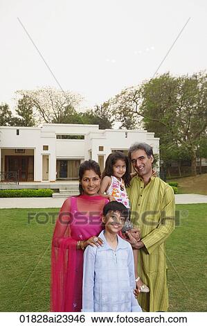 Stock Photograph - family in front of home. Fotosearch