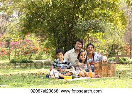 Stock Photo - Family in park with picnic. Fotosearch