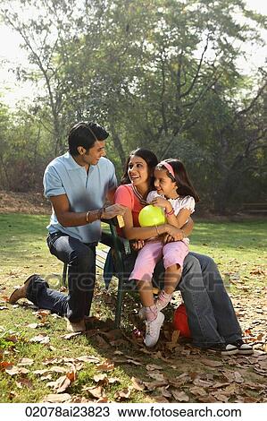 Family in park, yellow balloon View Large Photo Image Stock Image - Family in park, yellow balloon. Fotosearch