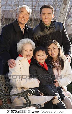 Family in the park smiling at camera View Large Photo Image Stock Image - Family in the park smiling at camera. Fotosearch