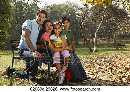 Family of four in park View Large Photo Image Stock Photograph - Family of four in park. Fotosearch