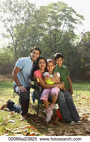 Stock Photography - Family of four in park. Fotosearch