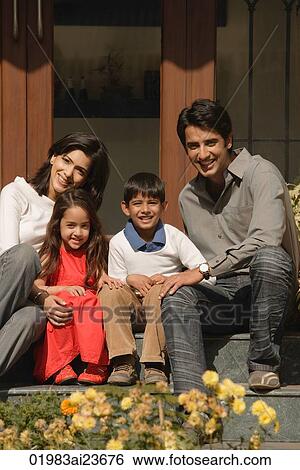 family of four sitting front doorstep, smiling at camera View Large Photo Image Stock Photograph - family of four sitting front doorstep, smiling at camera. Fotosearch